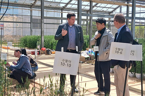 Dr. Andreas Stahl (links) vom JKI im Gespräch mit seinem koreanischen Kollegen Dr Hyundai Han (Mitte) bei der Besichtigung eines Trockenstress-Experiments am NICS. © C. Harms/JKI